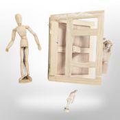 An artists folding paint box, two wooden mannequins and a further model of a hand.