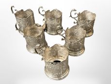 Six engraved white metal cup holders, probably Persian.