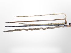 Five assorted walking sticks including two bamboo examples,