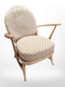 An Ercol elm and beech open arm chair.