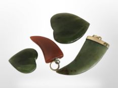 A polished jade claw pendant, length 4cm, similar agate pendant and two jade hearts.