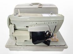 A Singer electric sewing machine with lead and pedal.