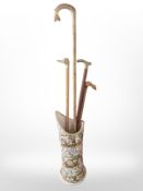 An ornate continental stick stand decorated with cherubs,