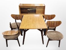 A 20th century G Plan teak drop leaf dining table, four chairs and matching sideboard designed by E.