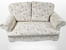 A modern floral upholstered two seater settee, length 153 cm.