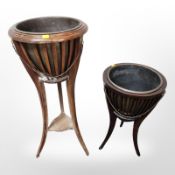 Two reproduction tripod jardiniere stands containing brass planters, tallest 89 cm.