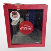 A Husky bench top bottle fridge with Coca Cola label