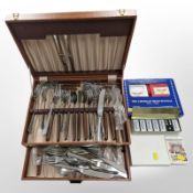 A canteen of assorted table cutlery, sets of playing cards,