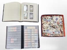 An album of stamps including British Overseas Colonies including some un-franked examples,