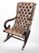 A mahogany framed Chesterfield buttoned tan leather rocking chair