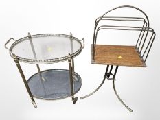 An oak and brass magazine stand and an oval glass topped trolley
