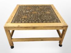 A Scandinavian pine square coffee table with specimen wood top,