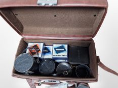 A camera bag containing Kominar 1:4.5 200mm lens, Topcon 1:3.5 F=135mm lens, a Kogaku 1:3.5 F=2.