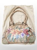A lady's stitched tan leather shoulder bag with floral decoration