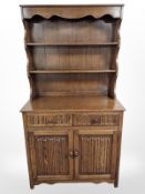 A reproduction oak linen fold dresser,