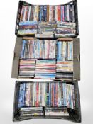 Three boxes containing a large quantity of DVDs.