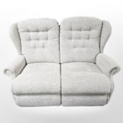 A contemporary two seater settee in oatmeal fabric, length 140 cm.