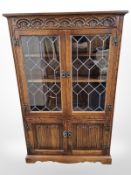 A reproduction carved oak linen fold double door cabinet,