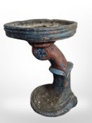 A painted concrete bird bath,