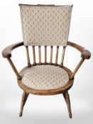A reproduction walnut spindle back elbow chair.