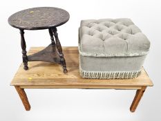 A contemporary pine coffee table, a heavily carved low circular table and a tassled foot stool.