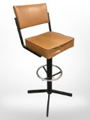 A metal and tan vinyl bar chair
