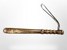 A turned wooden truncheon.