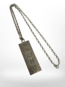 A silver ingot pendant, length 5cm, on chain.