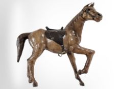 A leather figure of a horse, in the style of Liberty, height 31 cm.