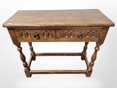A reproduction oak two drawer low side table,