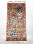 A machine made rug of Central Iranian Ghom design, 131 cm x 60 cm.
