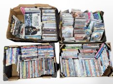 Four boxes containing a large quantity of assorted CDs and DVDs.