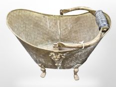 A Victorian brass coal bucket on paw feet, height 41 cm.