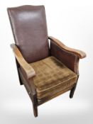 An early 20th century beech framed armchair with studded leather back rest, width 58 cm.