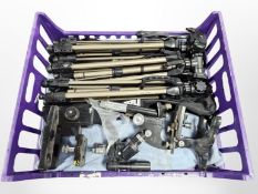 A group of folding camera tripods,