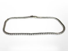 An 18ct white gold diamond line bracelet, set with 93 brilliant cut diamonds,