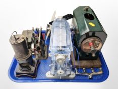 A group of live steam stationary engine components, a boiler on wooden plinth,