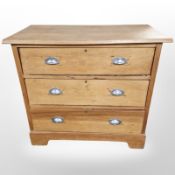 An early 20th century pine three drawer chest,