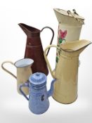 Five various enameled metal jugs, tallest 52 cm.