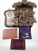 A heavily carved reproduction cuckoo clock, jewellery boxes and a small embroidered tray.