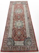 A machine-made runner of Central-Iranian Kashan design,