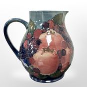 A Moorcroft jug, decorated with pomegranates and birds, height 14 cm.