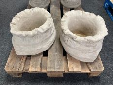 A pair of concrete sack planters, height 23cm.