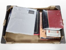 Several albums of colour postcards, stamp catalogue,