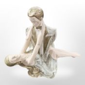 A painted plaster figure of a bride and groom,