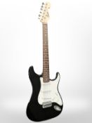 A Fender Squier Strat electric guitar.