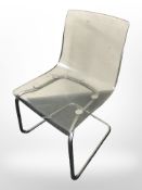 An IKEA chrome and plastic ghost chair.