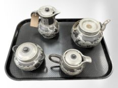 A four piece Chinese pottery tea service with pewter overlay.