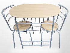 A modern metal framed kitchen table and two matching chairs.