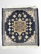 A small Iranian rug on indigo ground, 50 cm x 46 cm.